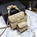 Detail of khaki textured handbag with block embossing and gold metal clasp closure - Khaki