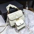 Detail showing cream leather satchel with pleated handle and mini pouch attachment - White
