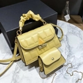 Detail view of ginger yellow quilted handbag set with cloud handle and chain bag - Yellow