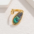 Macro view of water drop-shaped abalone shell inlay on an irregular gold adjustable ring - Teardrop Colorful Abalone Style (CXR916-E-cai)