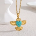 Bohemian gold eagle necklace with heart-shaped turquoise pendant on white minimalist stand - Eagle Heart Turquoise Style
