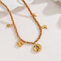 Retro gold chain necklace with woven brown leather cord and vintage metal charms - Hollow Round Pendant Style / Gold/Brown