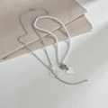 Detail of double-layer necklace with heart pendant, pearl strand and OT toggle clasp - Double Layer Heart Pearl Style