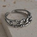 Detailed macro shot of vintage silver chain-link style adjustable ring on stone base - Industrial Chain & Polka Dot Style (R566)