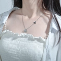 Detailed view of silver butterfly necklace worn on neck with dual charm pendants - Necklace / 45cm / Steel