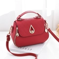 Red lychee texture cross-body bag with golden teardrop buckle and adjustable strap - Burgundy