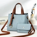 Detail of light blue litchi pattern tote bag with brown straps and matching small purse - Sky Blue