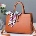 Brown leather handbag with gold twist lock and elegant patterned silk scarf on handle - Khaki/Earth Yellow