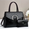 Macro shot of textured black leather handbag surface with metallic buckle and fine stitching - Black Vintage Texture