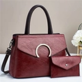 Macro shot of burgundy faux leather texture and gold C-shaped metal buckle on the handbag - Vintage Wine Red