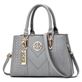 Grey textured leather handbag with gold metal accents and stylish V-shape stitching pattern - Gray