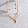 Collana a doppio strato con perline e ciondolo a corno dorato con pietra rossa - Doppio Strato