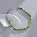 Unisex roestvrijstalen kralenarmband met groen-bruine stenen schijfjes en karabijnslot - Fruitgroen