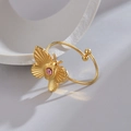 Macro detail of golden butterfly open ring with pink zircon and textured wings - Butterfly Zirconia Style