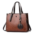 Brown PU leather tote bag with dark brown straps and a minimalist gold buckle design - Caramel color