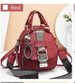 Detailed view of red soft PU leather backpack with star charm and striped strap - Red