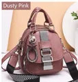 Detail of dusty pink backpack with litchi texture and metallic star charms on display - Dusty Pink