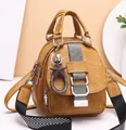 Detail of yellow soft leather backpack with stylish geometric strap and star pendant - Yellow