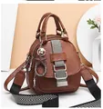 Detail of earth yellow pebbled leather backpack with sparkling silver strap and star charm - Khaki/Earth Yellow
