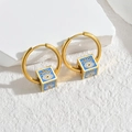 Golden hoop earrings with blue cube pendant featuring evil eye motif in enamel - Blue Eye