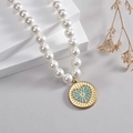 Vintage pearl necklace with a gold coin pendant featuring a blue radiant heart design - Green