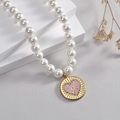 French vintage pearl necklace featuring a golden round pendant with a purple heart motif - Purple