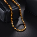 Tiger eye stone beaded necklace with 14K gold wavy spacers displayed on black jewelry box - Tiger Eye Brown