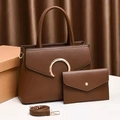 Dark brown tote bag set with envelope clutch and gold hardware on a textured backdrop - Brown