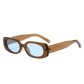 Retro oval sunglasses with translucent brown frames and light blue lenses in a 45-degree view - Tea Frame Blue Lens