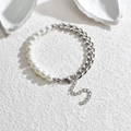 Silver Cuban chain and pearl hybrid bracelet with adjustable lobster clasp on stone texture - Steel