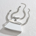 Dettaglio dei bracciali puzzle a cuore per coppia in argento con maglie a catena grumetta - Bracciale di Coppia Cuore-Catena NK