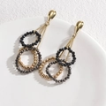 Modern gold tassel earrings with black and silver faceted beads in a variant style - Black Gold Geometric Rings (E639)