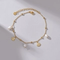 Gold stainless steel anklet with shell charms and pearls on a minimalist grey background - Gold