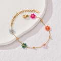 Golden stainless steel chain bracelet featuring five colorful beaded flower charms - Flower Bracelet