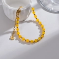 Yellow faceted bead bracelet with golden stainless steel clasp and S.Steel round tag - Yellow