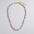 Detailed close-up of rainbow faceted beaded necklace with golden lobster clasp and chain - Colorful Beaded Necklace