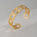 Gold-toned hammered texture cuff bracelet with minimalist oval crossover chain design - Gold