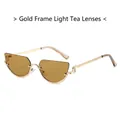 Occhiali da sole moderni con montatura dorata e lenti cat-eye marrone chiaro su bianco - Montatura Oro Lente Tè Chiaro