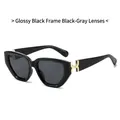 Chic black sunglasses with grey lenses and premium golden metal hinge accents - Glossy Black Frame Grey Lens