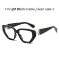 Trendy cat-eye sunglasses with bright black frame, clear lens, and golden H-shaped hardware - Glossy Black Frame / Clear Lenses
