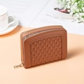 Close-up of warm brown quilted leather wallet with gold zipper in a lifestyle setting - Brown