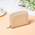 Detail view of cream quilted PU leather short wallet with gold metal zipper and smooth texture - Apricot