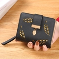 Women's short black PU leather wallet featuring hollow leaf design and gold pendant - Black