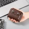 Close-up of brown leather card wallet featuring orange stitching and metal snap buttons - Coffee