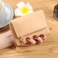 Three-fold beige faux leather mini wallet with gold zipper in a lifestyle setting - Honey Yellow