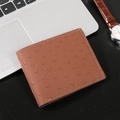 Brown ostrich embossed leather wallet for men in a professional business desk setting - Brown