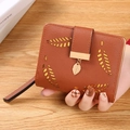 Brown faux leather bifold wallet with hollow leaf design and metallic leaf pendant - Brown