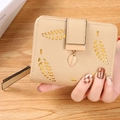 Beige faux leather short wallet for women featuring hollow leaf design and gold pendant - Khaki