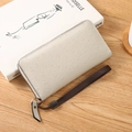 Beige faux ostrich leather long wallet with zipper and brown wrist strap for women - Off White