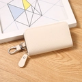 Chic beige lychee grain PU leather key pouch with silver swivel hook and zip closure - Off White